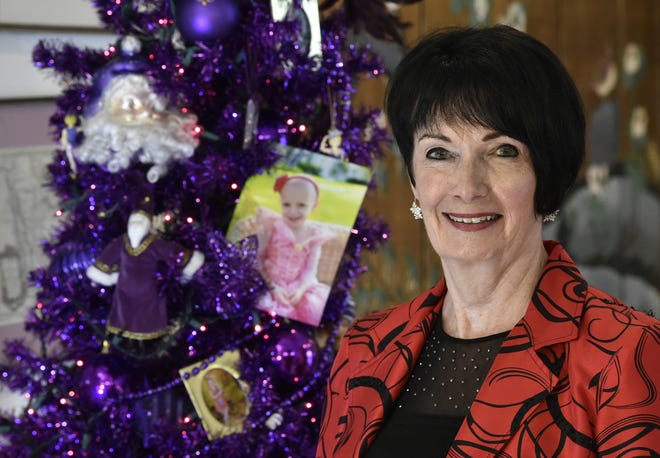 The 5-year-old granddaughter of Kay Siebold and her husband, Wayne, off camera, died three years ago from brain cancer. The family now collects toys to give to patients at All Children's Hospital in St. Petersburg in Teeja's memory. In this Dec. 15 photo, Kay poses with Teeja's purple tree. [Herald-Tribune staff photo / Thomas Bender]