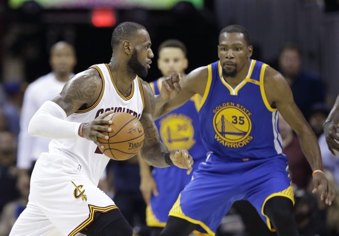 Cleveland Cavaliers forward LeBron James (23) drives on Golden State Warriors forward Kevin Durant (35) during the second half of Game 4 of the NBA Finals in Cleveland. The NBA is driven by star power and its Christmas Day lineup is about the league's best players, not all the best teams. [The Associated Press / Tony Dejak]