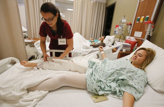 Nursing student Jennifer Moore, left, takes care of fellow student Megan Beavers at the University of Alabama Capstone College of Nursing during a training simulation. Experts say a funding crisis could lead hospitals across Alabama to educe their services, layoff their employees or close their doors. [Staff Photo/Gary Cosby Jr.]