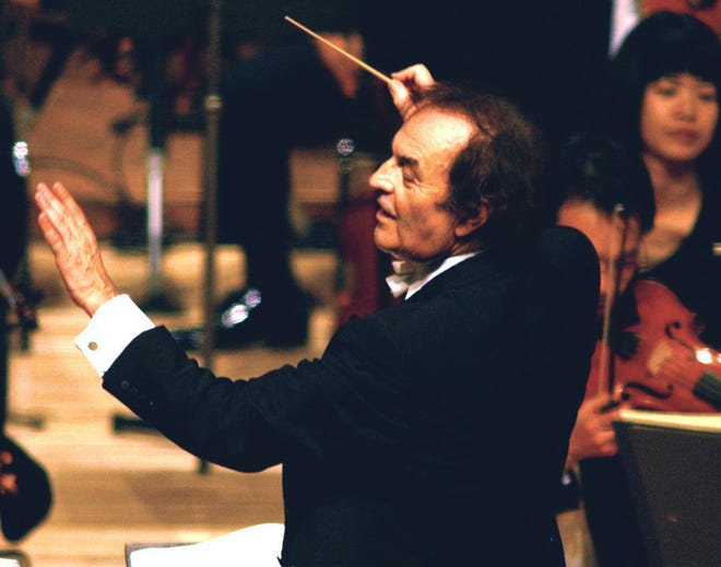 Conductor Charles Dutoit performs with NHK Symphony Orchestra in Tokyo, Japan on June 19, 2003. A Canadian orchestra is launching an investigation in the wake of sexual assault allegations against Dutoit. (Kyodo News via AP)