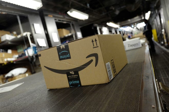 In this Tuesday, May 9, 2017, photo, a package from Amazon Prime moves on a conveyor belt at a UPS facility in New York. Online shoppers will pay close attention to at least two things this holiday season: shipping costs and return deadlines. (AP Photo/Mark Lennihan)