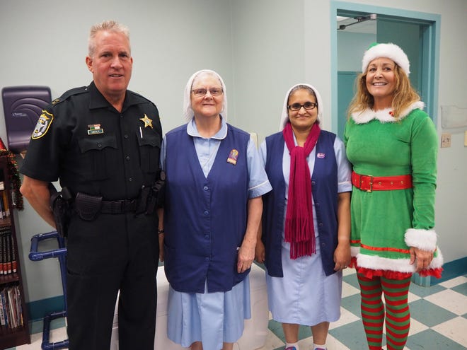 Pictured from left: Captain Robert Mealy, Manatee County Sheriff's Office; Sister Gilchrist and Sister Solana of The McKay Academy; and Sandy Garett of the Manatee County Sheriff's Office. / COURTESY PHOTO