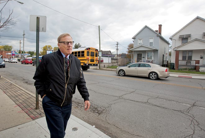 City attorney Rick Pfeiffer walks down Parsons Avenue near the United Methodist Church for All People