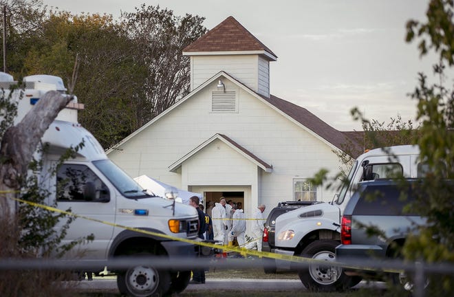 FILE - In this Nov. 5, 2017, file photo, investigators work at the scene of a deadly shooting at the First Baptist Church in Sutherland Springs, Texas. New York City, San Francisco and Philadelphia filed a federal lawsuit Tuesday, Dec. 26, against the Defense Department, saying many service members who are disqualified from gun ownership weren't reported to the national background check system. A Defense Department failure allowed a disgraced former Air Force member to buy a high-powered rifle and shoot 26 people to death at the church. (Jay Janner/The San Antonio Express-News via AP, File)