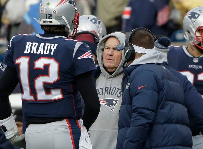 New England Patriots head coach Bill Belichick, center, speaks to quarterback Tom Brady, left, during a timeout in the first half of an NFL football game against the Buffalo Bills, Sunday, Dec. 24, 2017, in Foxboro.