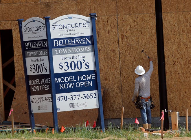 FILE - In this Tuesday, May 16, 2017, file photo, a construction worker continues work on new town homes under construction in Woodstock, Ga. The Standard & Poor's CoreLogic Case-Shiller home price index, which tracks the value of homes in 20 major U.S. metropolitan areas, is due out Tuesday, Dec. 26, 2017. (AP Photo/John Bazemore, File)