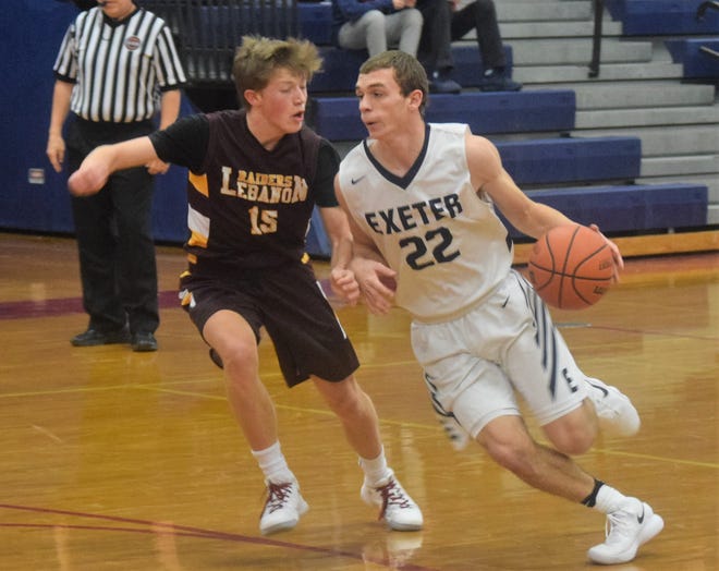 Exeter High School guard Cody Morissette, right, drives past Lebanon's Logan Falzarano during Tuesday's first-round game in the Queen City Invitational Basketball Tournament in Manchester. [Mike Zhe/Seacoastonline.com]
