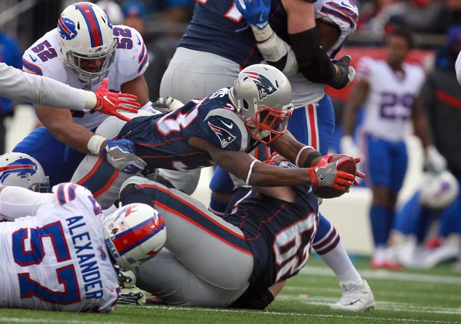 Patriots running back Dion Lewis stretches out to gain a first down in the third quarter on Sunday.