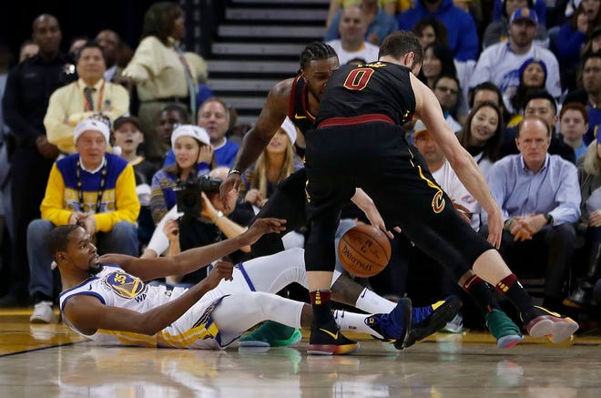 Cleveland Cavaliers forward Kevin Love (0) steals the ball from Golden State Warriors forward Kevin Durant (35) during the first half of an NBA basketball game in Oakland, Calif., Monday, Dec. 25, 2017. (AP Photo/Tony Avelar)