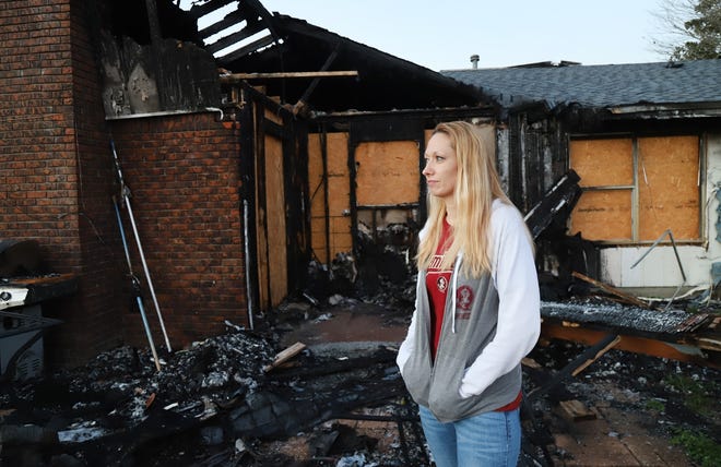 Dawn Kennedy stands behind her fire-damaged Mary Esther home recently as she recalls the Oct. 2 blaze and the enormous amount of support and donations her family has received from people at Eglin AFB. [MICHAEL SNYDER/DAILY NEWS]