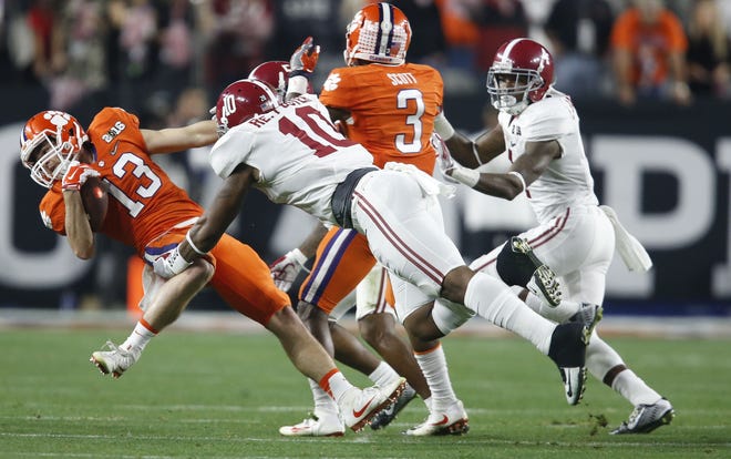 Clemson wide reciever Hunter Renfrow (13) is brought down by Alabama linebacker Reuben Foster (10) during the first half of the College Football National Championship game in the University of Phoenix Stadium Monday, January 11, 2016. [Staff file photo/Gary Cosby Jr.]