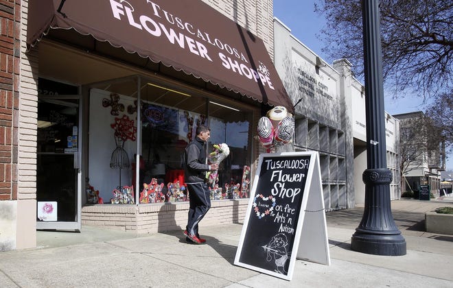 Steve Salzarulo walks out of the Tuscaloosa Flower Shoppe with a bouquet of flowers for his wife Petra in Tuscaloosa on Friday Feb. 13, 2015. [Staff photo/Erin Nelson]