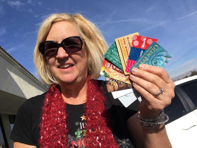 Barbara Little of Oak Hills shows off a few of her unused gift cards that she’s received over the years. For a variety of reasons, millions of dollars worth of cards go unspent by customers across the nation each year. [Rene Ray De La Cruz, Daily Press]