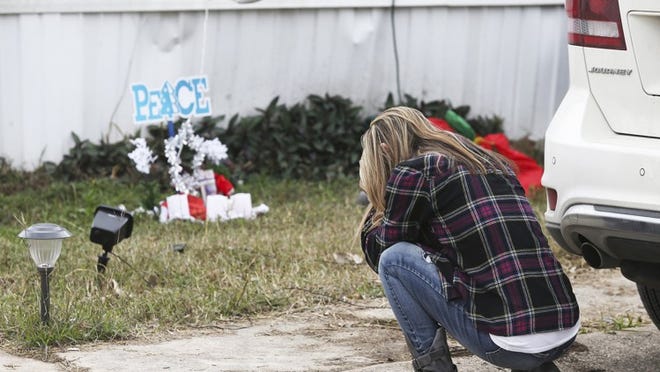 A woman who stopped her car weeps on the curb in front of a memorial Friday for a boy who was fatally wounded by deputies in a mobile home park in Schertz on Dec. 21. The 6-year-old boy, Kameron Prescott, was killed by a stray bullet when deputies near San Antonio opened fire on a woman being sought for crimes. The woman, Amanda Jones, also was shot and killed by the deputies. TOM REEL / SAN ANTONIO EXPRESS-NEWS