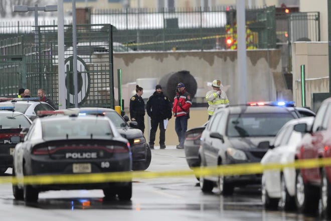 Law enforcement investigate by the loading dock after an incident in the Lambeau Field parking lot on Friday, Dec. 22, 2017, in Green Bay, Wis. Police say a fired food service worker rammed a former co-worker's car at Lambeau Field, bringing numerous law enforcement agencies to the Green Bay Packers' stadium. (Adam Wesley/The Green Bay Press-Gazette via AP)