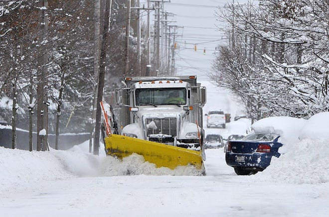 On Dec. 26, a City of Erie plow clears snow on Cherry Street after a record snow event that dumped at least 55 inches of snow over two days. [GREG WOHLFORD/ERIE TIMES-NEWS]