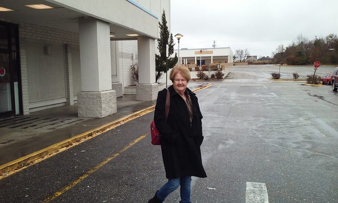Pasty Lee of Kinston gets out of the cold Wednesday by shopping at Belk. [The Free Press]