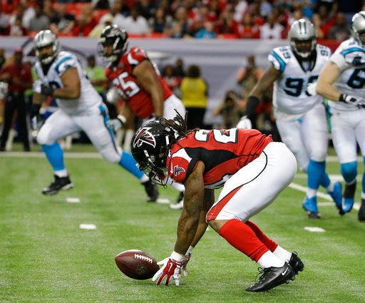 File- This Dec. 27, 2017, file photo shows Atlanta Falcons running back Devonta Freeman (24) fumbling the ball on a run against the Carolina Panthers during the first half of an NFL football game, in Atlanta. Mistakes, including costly fumbles by Devonta Freeman in last week's loss at New Orleans, red zone woes and third-down problems have hurt the Atlanta Falcons all season and left the team needing a win over Carolina on Sunday to guarantee a playoff spot. (AP Photo/David Goldman, File)
