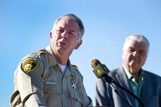 Clark County Sheriff Joe Lombardo, left, and Clark County Commission Chairman Steve Sisolak respond to questions during a news conference on New Year's Eve security at Metro Police Headquarters in Las Vegas Wednesday, Dec. 27, 2017. Glass bottles, backpacks and coolers are not permitted on The Strip on New Year's Eve, police said. (Steve Marcus/Las Vegas Sun via AP)