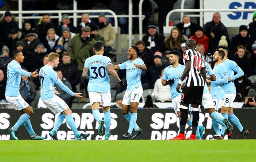 Manchester City's Raheem Sterling, center, celebrates with teammates after scoring his side's first goal of the game during their English Premier League soccer match against Newcastle United at St James' Park, Newcastle, England, Wednesday, Dec. 27, 2017. (Owen Humphreys/PA via AP)