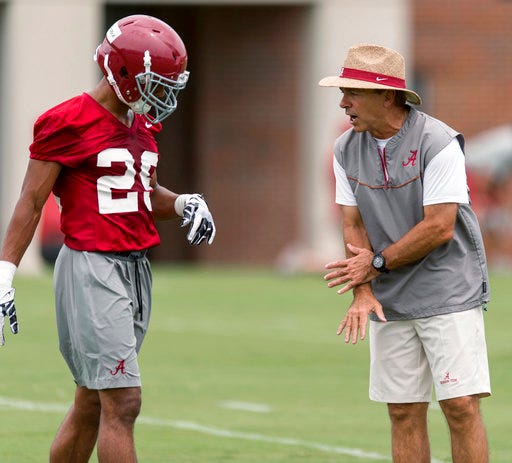 This photo taken Aug. 7, 2015, shows Alabama coach Nick Saban working with defensive back Minkah Fitzpatrick during NCAA college football practice in Tuscaloosa, Ala. Replacing loads of talent is nothing new for either team. Alabama has produced more NFL draft picks (65) over the past nine years than any other program, including 22 first-rounders. Fitzpatrick is a unanimous All-American who won the Chuck Bednarik and Jim Thorpe awards as the nation's top defensive player and defensive back, respectively. (Vasha Hunt/AL.com via AP)