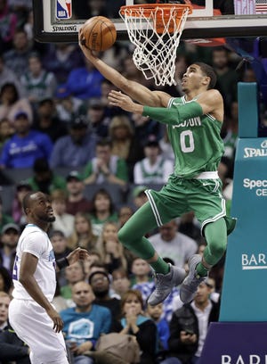 Boston's Jayson Tatum drives to the basket past Charlotte's Kemba Walker during NBA action Wednesday. [AP photo]
