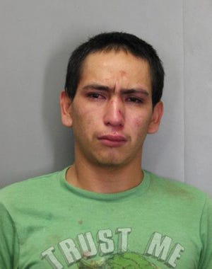 This December 2017 photo released by the Official Fairfax County Police Department shows Wilmer Lara Garcia, wearing a T-shirt emblazoned with “Trust Me”, who was charged with auto theft and two counts of forgery after allegedly stealing a car with an accomplice in Fairfax County, Va. (Official Fairfax County Police Department via AP)