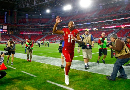File-This Dec. 24, 2017, file photo shows Arizona Cardinals wide receiver Larry Fitzgerald (11) leaving the field after an NFL football game against the New York Giants in Glendale, Ariz. Fitzgerald might well be the most popular athlete in the history of the state of Arizona. The wide receiver’s resume is packed with Hall of Fame-caliber statistics accumulated over 14 seasons with the same Cardinals team that drafted him third overall in 2004. Add to that his easy-going personality combined with a remarkable durability _ he’s missed six games of his 208 games since joining the league. A year ago, Fitzgerald and the Giants’ Eli Manning shared the NFL man of the year award his work off the field.
And impressively, at age 34, on the field he’s still playing at it at a high level, all while staying mum on whether he will return for another season.(AP Photo/Ross D. Franklin, File)