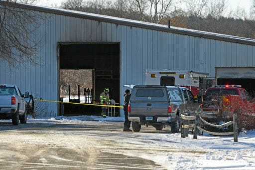Fire officials investigate the cause of a fire at Folly Farm in Simsbury, Conn., Thursday, Dec. 28, 2017. The owners of the Connecticut equestrian training and boarding farm said many horses died in the fire at their barn.  (John Woike/Hartford Courant via AP)