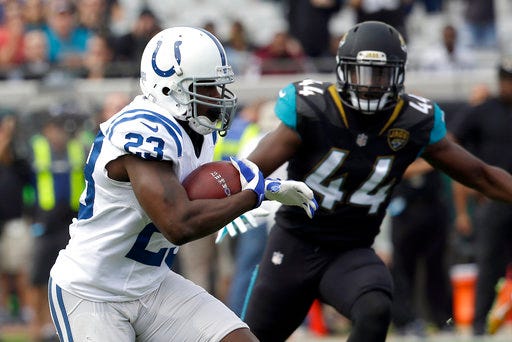 FILE - In this Dec. 3, 2017, file photo, Indianapolis Colts running back Frank Gore (23) runs past Jacksonville Jaguars linebacker Myles Jack (44) for a short gain during the first half of an NFL football game in Jacksonville, Fla. On Wednesday, Gore and teammate Adam Vinatieri acknowledged they would each like to play another season, meaning Sunday's season finale against Houston won't become a retirement party. "I know I still can play, and I know I want to help a team," Gore said. "I don't want to just be part of a team, I want to help a team, and I don't want anyone to say I rode the bench to get a ring." (AP Photo/John Raoux, File)