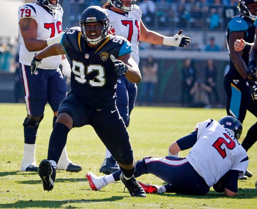 File- This Dec. 17, 2017, file photo shows Jacksonville Jaguars defensive lineman Calais Campbell (93) celebrating after sacking Houston Texans quarterback T.J. Yates (2) during the first half of an NFL football game in Jacksonville, Fla. The Jacksonville Jaguars intend to play and sound eager for a little payback against the only divisional team to beat the AFC South champs. The Tennessee Titans know a win clinches an elusive postseason berth for themselves in a game that could be a playoff preview. (AP Photo/Stephen B. Morton, File)