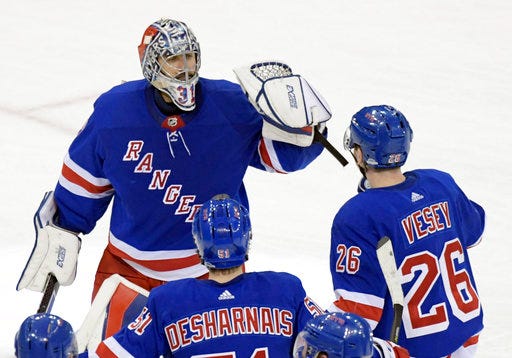 New York Rangers goalie Ondrej Pavelec (31) celebrates with left wing Jimmy Vesey (26) and center David Desharnais (51) after the Rangers defeated the Washington Capitals 1-0 in a shootout of an NHL hockey game, Wednesday, Dec. 27, 2017, at Madison Square Garden in New York. (AP Photo/Bill Kostroun)