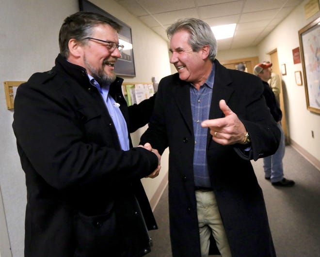 Re-elected Portsmouth Mayor Jack Blalock, right, congratulates the city's next Assistant Mayor Cliff Lazenby at City Hall following the election in November. The new council will be seated Jan. 2. [Ioanna Raptis/Seacoastonline, file]