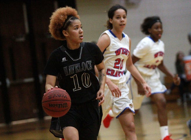 Havelock's Aniylah Bryant (10 in black) dribbles down the court as West Craven's Harmony Campbell (20) and Kiana Harris give chase. Bryant scored 21 points as Havelock won 60-46. [Gray Whitley / Sun Journal Staff]