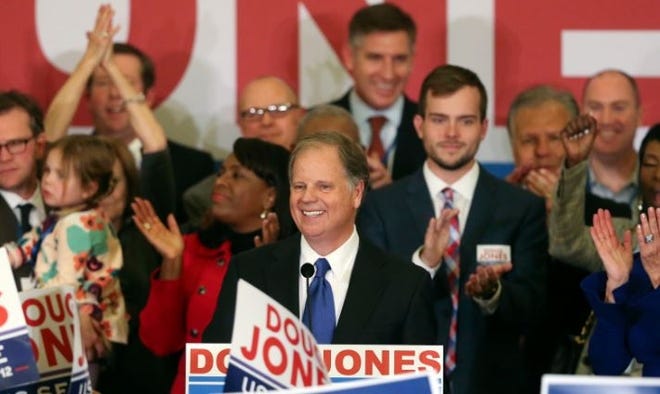 FILE - In this Tuesday, Dec. 12, 2017 file photo, Democrat Doug Jones speaks in Birmingham, Ala. Roy Moore is going to court to try to stop Alabama from certifying Jones as the winner of the U.S. Senate race. Moore filed a lawsuit Wednesday evening, Dec. 27, 2017, in Montgomery Circuit Court. (AP Photo/John Bazemore, File)