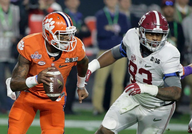 FILE - In this Jan. 11, 2016, file photo, Clemson quarterback Deshaun Watson, left, tries to get away from Alabama’s Jonathan Allen during the first half of the NCAA college football playoff championship game in Glendale, Ariz. Clemson and Alabama will meet Monday in the College Football Playoff for the third straight year when they square off in the Sugar Bowl. After finishing third in the Heisman voting, Watson passed for 405 yards and four touchdowns against ‘Bama while running for 73 yards in the 2016 game. (AP Photo/Chris Carlson, File)