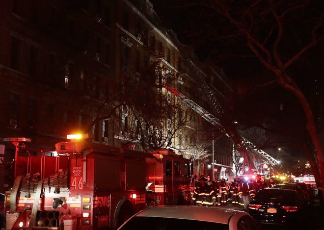 Firefighters respond to a building fire Thursday n the Bronx borough of New York. [AP Photo/Frank Franklin II]