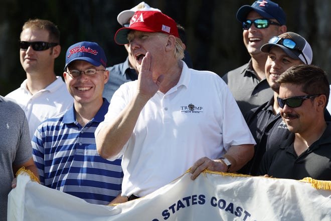 President Donald Trump speaks as he meet with members of the U.S. Coast Guard, who he invited to play golf, at Trump International Golf Club, Friday, Dec. 29, 2017, in West Palm Beach, Fla. (AP Photo/Evan Vucci)