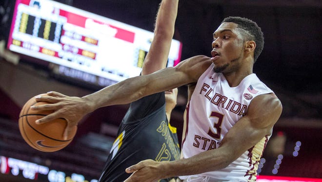 Florida State guard Trent Forrest (3) makes a no-look pass behind Southern Miss forward Tim Rowe during the Seminoles’ 98-45 victory over Southern Miss last week. FSU opens its ACC schedule on Saturday at Duke. (AP Photo/ Mark Wallheiser)