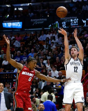 Brooklyn Nets' Joe Harris (12) is fouled by Miami Heat's Josh Richardson (0) while attempting a 3-point basket during the first half of an NBA basketball game Friday, Dec. 29, 2017, in Miami. (AP Photo/Lynne Sladky)