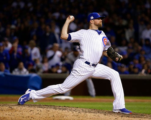 FILE - In this Wednesday, Oct. 18, 2017, file photo, Chicago Cubs relief pitcher Wade Davis throws during the ninth inning of Game 4 of baseball's National League Championship Series against the Los Angeles Dodgers, in Chicago. The Colorado Rockies added a significant piece to what’s becoming a formidable and high-priced bullpen by agreeing to a three-year, $52 million contract with All-Star reliever Wade Davis, a person familiar with the negotiations told The Associated Press, on Friday, Dec. 29. (AP Photo/Nam Y. Huh, File)