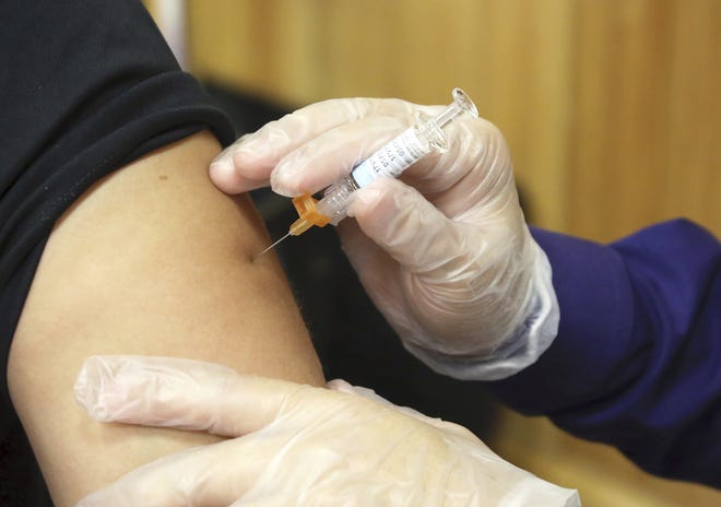 A flu vaccine injection is administered by a pharmacist. According to data released by the Centers for Disease Control and Prevention, this year’s flu season is off to a quick start and so far seems to be dominated by a nasty bug. [MIGUEL ROBERTS/AP]