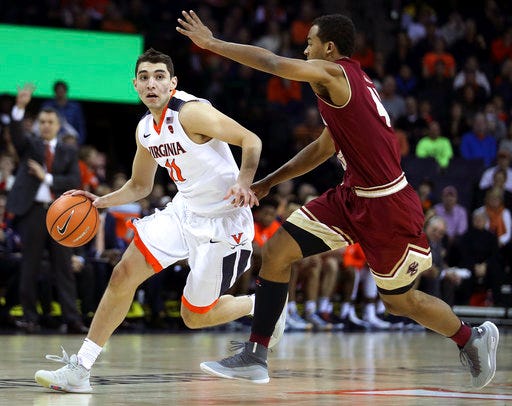 Virginia's Ty Jerome (11) drives past Boston College's Steffon Mitchell (41) in the first half of an NCAA college basketball game Saturday, Dec. 30, 2017, in Charlottesville, Va. (Zack Wajsgras /The Daily Progress via AP)