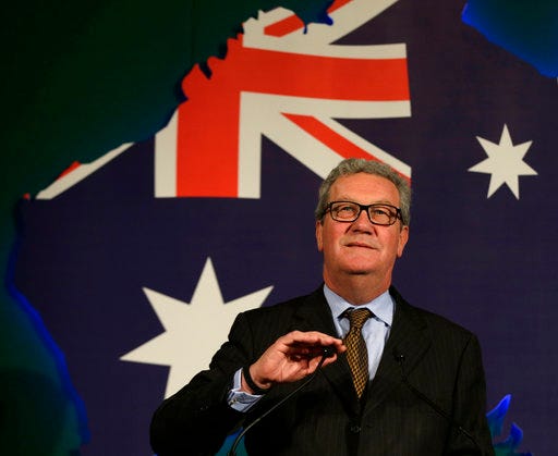File- This June 22, 2015, file photo shows Australian High Commissioner Alexander Downer, left, speaking to guests during a welcome party at the Australian High Commission in London. Trump campaign adviser George Papadopoulos told the diplomat, Downer, during a meeting in London in May 2016 that Russia had thousands of emails that would embarrass Democratic candidate Hillary Clinton, the report said. Downer, a former foreign minister, is Australia’s top diplomat in Britain. Australia passed the information on to the FBI after the Democratic emails were leaked, according to The Times, which cited four current and former U.S. and foreign officials with direct knowledge of the Australians’ role. (AP Photo/Alastair Grant, File)