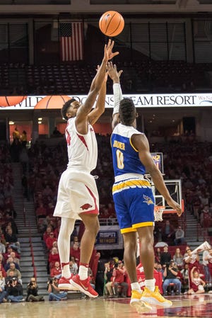 Arkansas' Daryl Macon shoots over a California State University-Bakersfield defender on Wednesday, Dec. 27, 2017, at Bud Walton Arena in Fayetteville. [CRANT OSBORNE/SPECIAL TO NATE ALLEN SPORTS SERVICE]