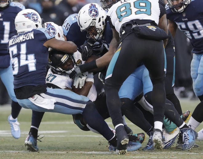 Jaguars running back Leonard Fournette (27) is stopped by Tennessee Titans inside linebacker Avery Williamson (54) in the first half of an NFL football game Sunday, Dec. 31, 2017, in Nashville, Tenn. (AP Photo/James Kenney)