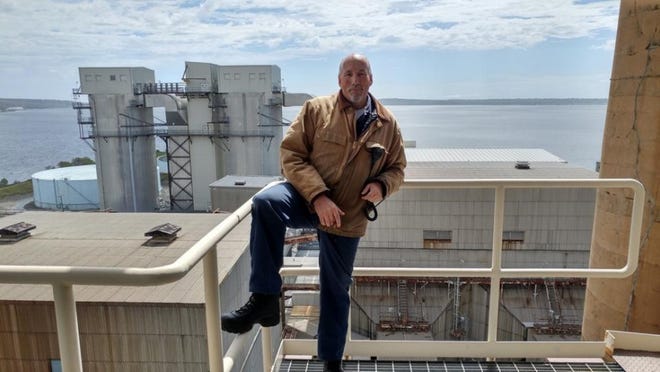 John Roman of Somerset, who spent the last 10 of his 29 1/2 years at Brayton Point as a watch engineer, stands atop Turbine 3 overlooking Mount Hope Bay. [Submitted photo]