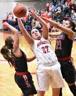 Minerva's Lauren Frigyes (32) brings down one of her game-high 16 rebounds. She also finished with 10 points.