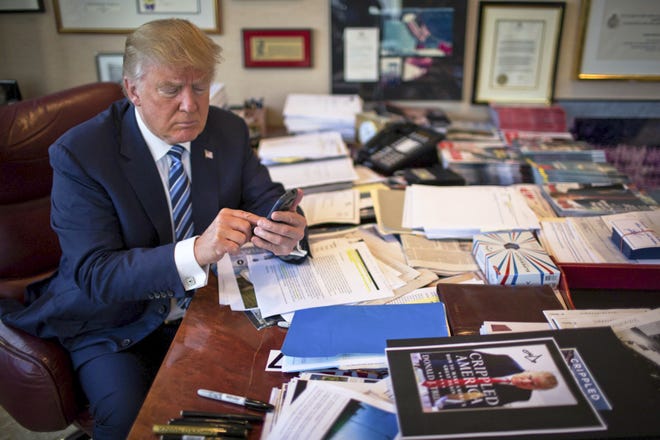 FILE-- Donald Trump demonstrates his tweeting skills in his office at Trump Tower in New York, Sept. 29, 2015. (Josh Haner/The New York Times)