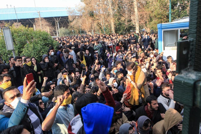 In this photo taken by an individual not employed by the Associated Press and obtained by the AP outside Iran, university students attend a protest inside Tehran University while anti-riot Iranian police prevent them to join other protestors, in Tehran, Iran, Saturday, Dec. 30, 2017. A wave of spontaneous protests over Iran's weak economy swept into Tehran on Saturday, with college students and others chanting against the government just hours after hard-liners held their own rally in support of the Islamic Republic's clerical establishment. (AP Photo)